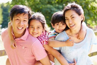 Asian family of four smiling