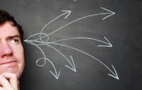 man with a thinking expression against a chalkboard. arrows drawn to come out of his head