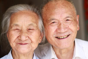 Older Asisan couple smiling