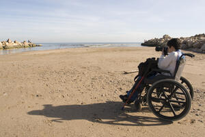 Man in wheelchair at the beach