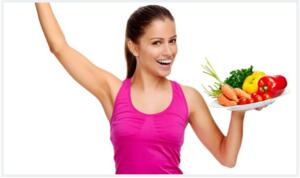 woman working out and holding plate of vegetables